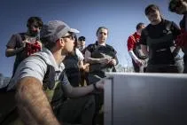 Photo : un agent de l'OFB présente le matériel de pêche à l'électricité aux étudiants