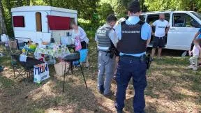 Photo d'un gendarme et d'un agent de l'OFB contrôlant une famille qui campe.